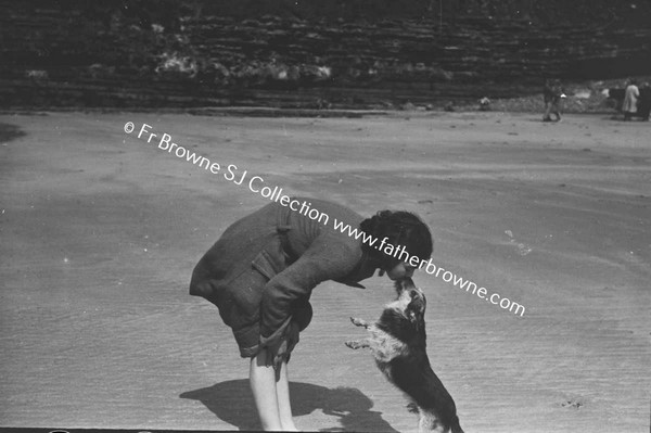 WOMAN WITH DOG ON BEACH